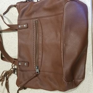 The SAK brown leather bag w/several zipper compartments like new condition